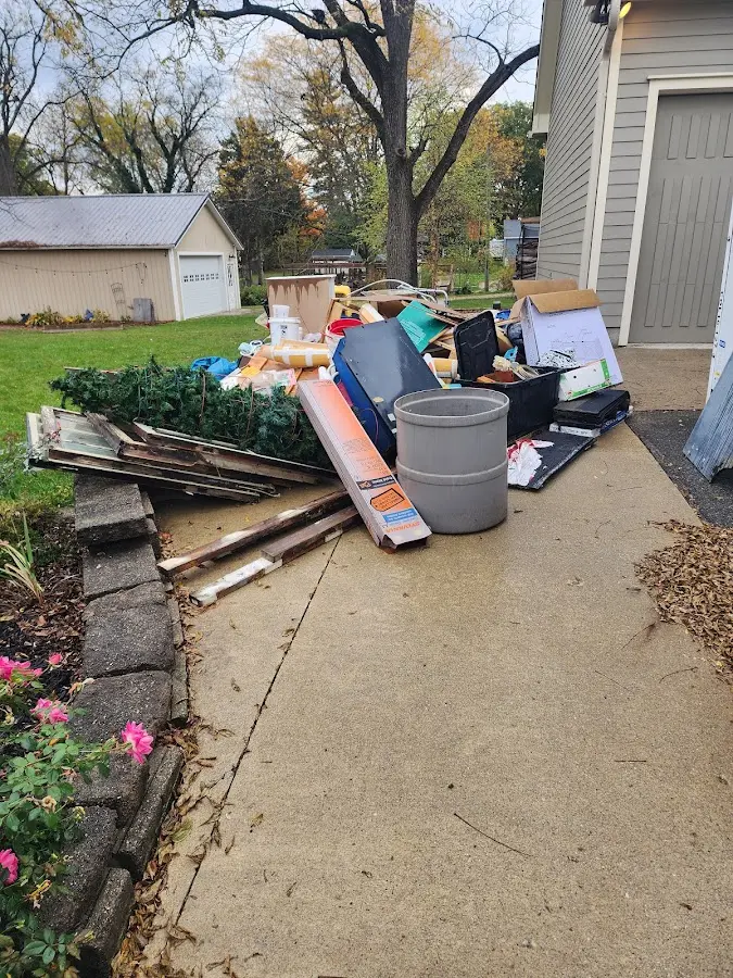 Dumpster being loaded with debris for 12 Yard Dumpster Rental in Sayre